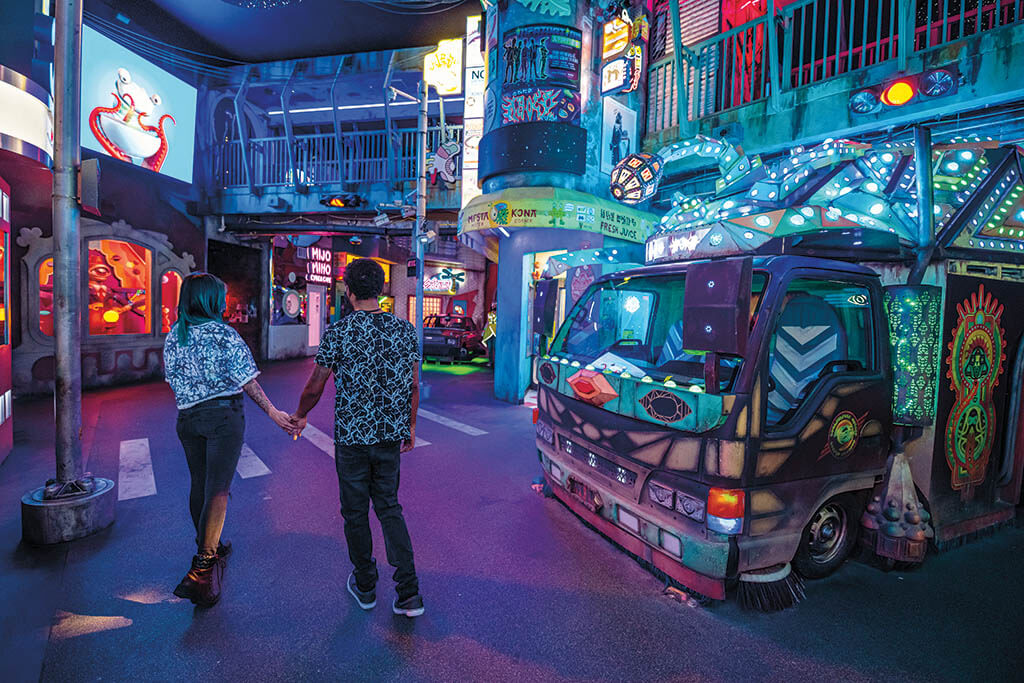 Experiential C Street in Convergence Station is a promenade of vivid colors and concepts. Meow Wolf’s guests interact with tech layers, like RFID cards, laser-based puzzles and reactive projection mapping. (Photo: Jess Bernstein. Image courtesy of Meow Wolf)