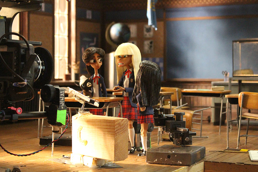 Extensive detail went into creating miniature props for the sets, such as desks situated in the classrooms of Rust Bank’s all-girls Catholic School.