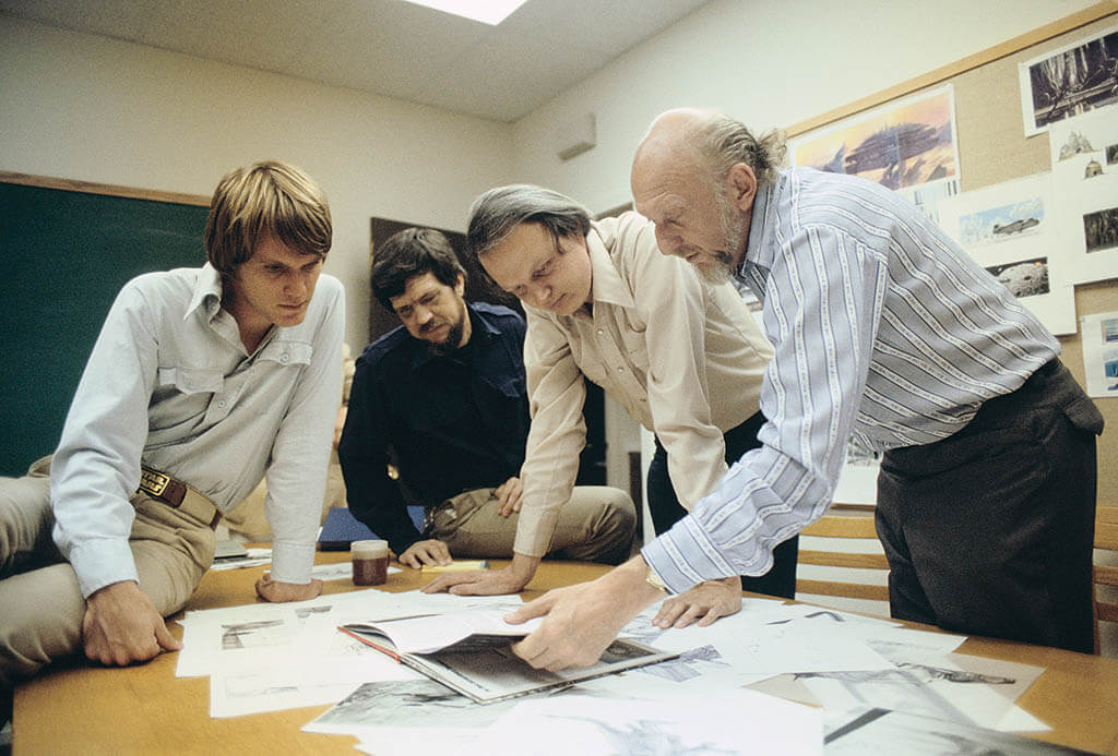 Visual Effects Art Director Joe Johnston,Special Visual Effects Supervisor Richard Edlund, VES and Dennis Muren, VES have a discussion with filmmaker Irvin Kershner about The Empire Strikes Back, with concept art for Cloud City in the background. 