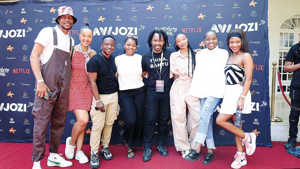 Chocolate Tribe hosts what has become the annual AVIJOZI festival with Netflix. AVIJOZI is a two-day, free-access event in Johannesburg focused on Animation/Film, Visual Effects and Interactive Technology. This year’s AVIJOZI is scheduled for September 13-14 in Johannesburg. Photo: Casting Director and Actor Spaces Founder Ayanda Sithebe (center in black T-shirt) and friends at AVIJOZI 2024.