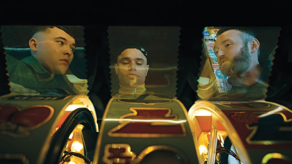 From left: Liam Óg Ó hAnnaidh (Mo Chara), Naoise Ó Cairealláin (Móglaí Bap) and J.J. Ó Dochartaigh (DJ Próvaí) in Kneecap, with VFX by Outer Limits Post Production adding to the distinct aesthetic of the film. Kneecap is a Belfast-based, Irish-language hip-hop group.(Image courtesy of Outer Limits) 