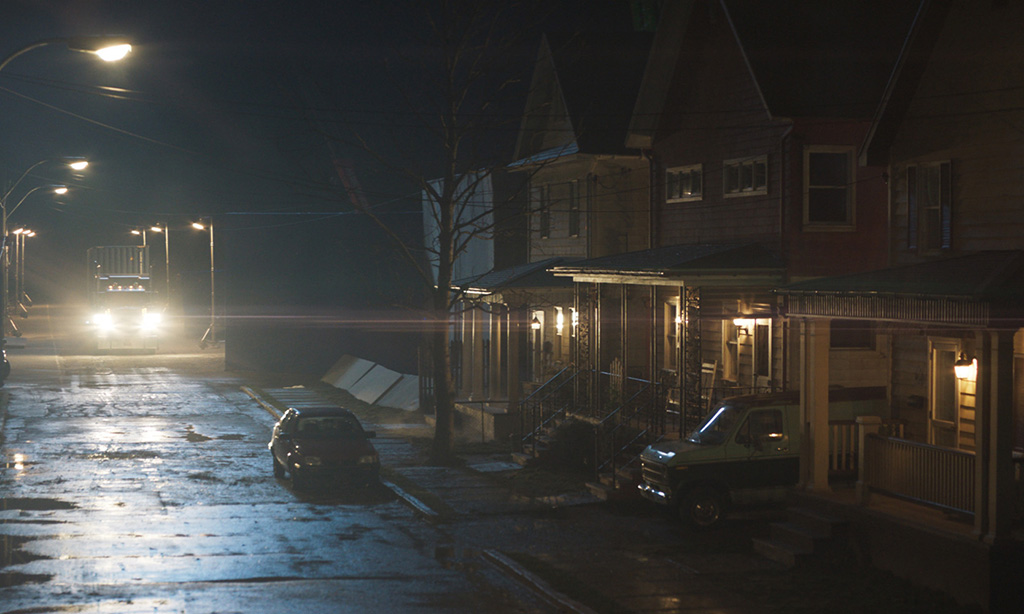Set dressing, like wet asphalt and lights in the distance, provided the desired scope and mood for the nighttime shots. 