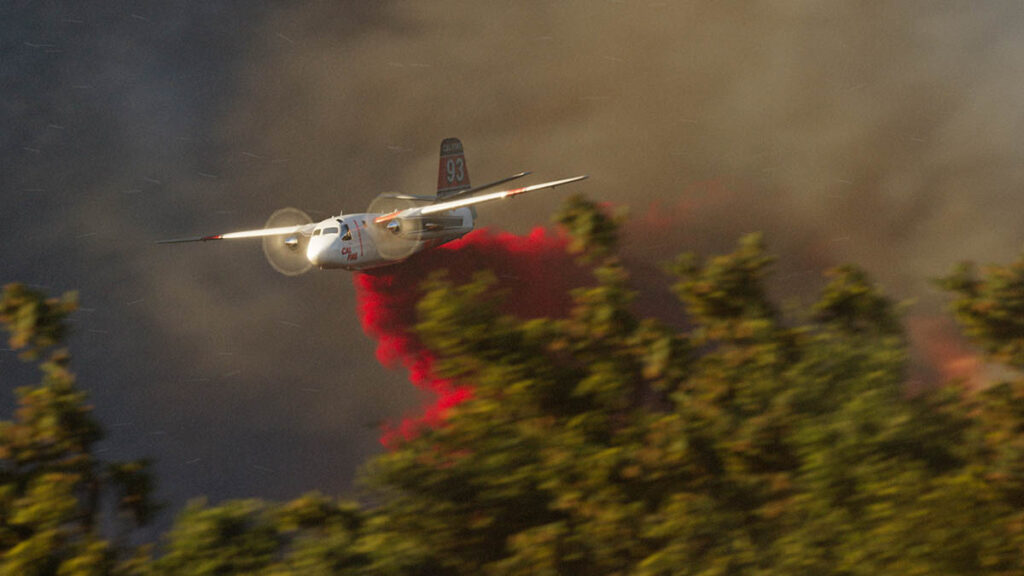 Fire retardant gets dropped under extremely windy conditions.