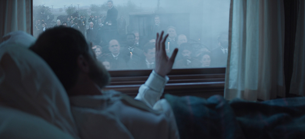 While live-action extras occupy the foreground, digital extras were added to the mid-ground and background to get the desired crowd waiting for James Garfield (Michael Shannon) at the train station.