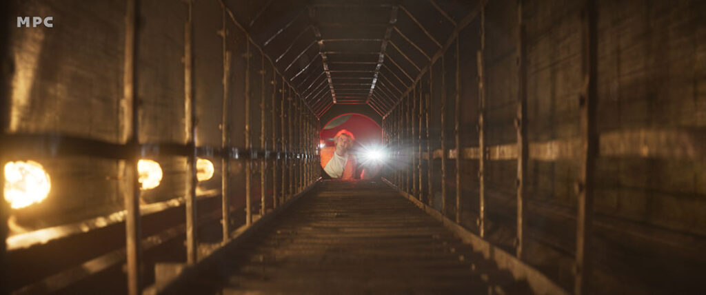 A partially constructed tunnel is transformed into an ominous environment.