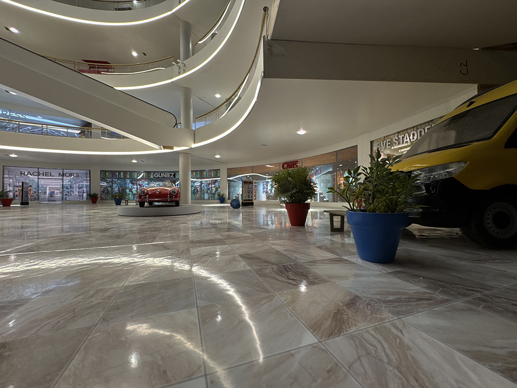 The Velvet Gang's getaway van lurks inside the first floor of the mall near a Cans shoe store and a classic red convertible.