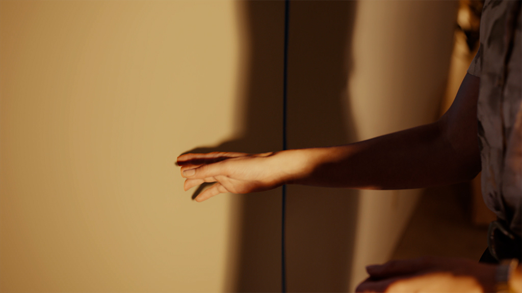 The actors performed the clipping movements naturally on set, with VFX adding the walls back around them as they passed through.
