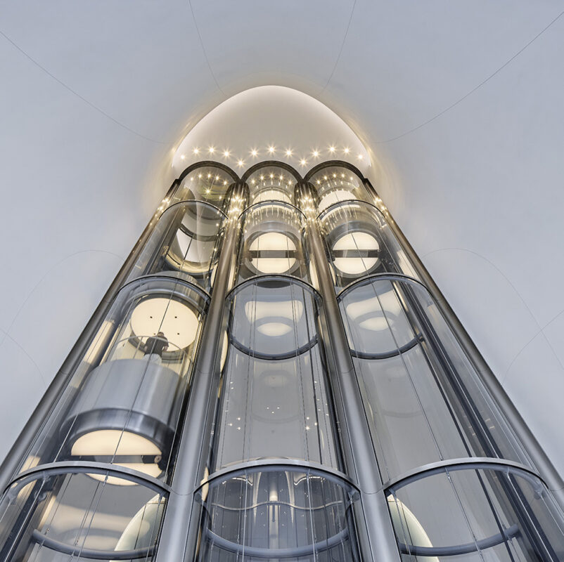 Pneumatic-style glass elevators offer visitors a futuristic lift to the main gallery. (Photo by Hufton Crow)