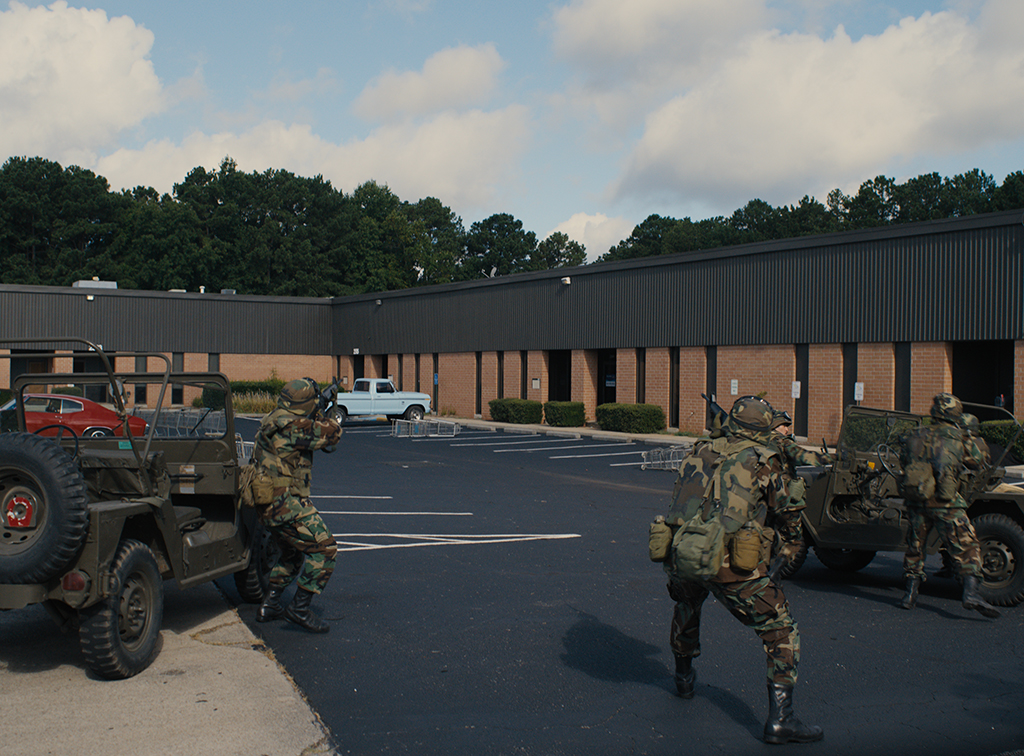 A strip-mall parking lot becomes a battleground between the military and an Allosaurus.
