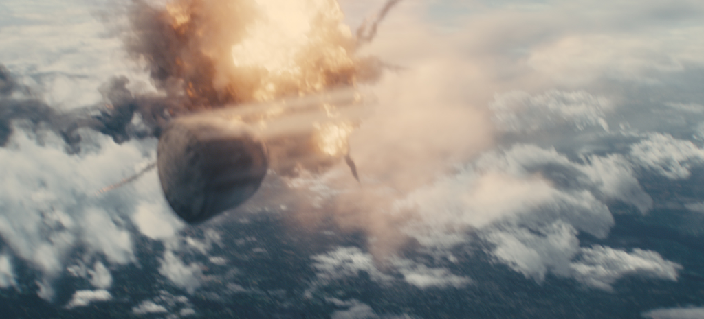 A CG MiG-21 fighter fires heat-seeking missiles, causing a mid-air explosion that alters Soyuz’s re-entry trajectory.
