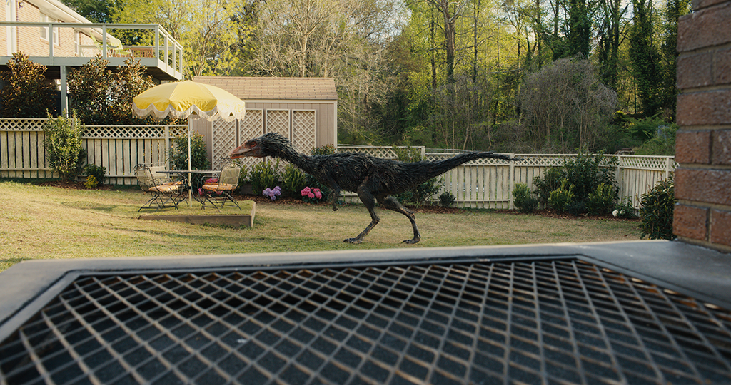 A backyard becomes the hunting ground for a Coelophysis.